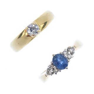 Two diamond and gem-set rings. To include a circular-cut diamond single-stone band ring and an oval-