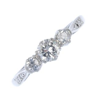 A diamond three-stone ring. The brilliant-cut diamond, with old-cut diamond sides, to the diamond ac