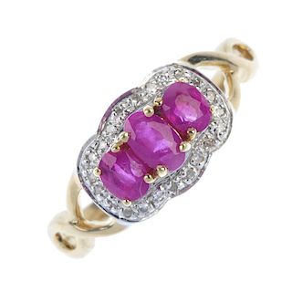 A 9ct gold ruby and diamond dress ring. The graduated oval-shape ruby line, within a single-cut diam