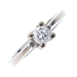 A diamond single-stone ring. The brilliant-cut diamond, within a floral bud mount, to the tapered sh