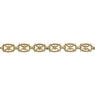 A bracelet. Designed as a series of oval-shape links, with banded cross spacers, to the partially co