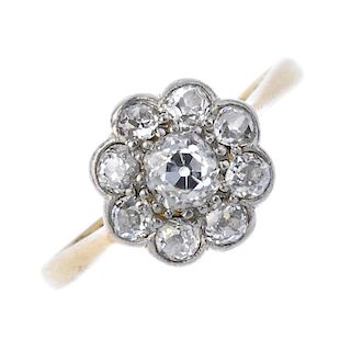 A mid 20th century platinum and 18ct gold diamond cluster ring. The old-cut diamond floral cluster,