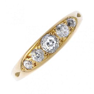 A mid 20th century 18ct gold diamond five-stone ring. The graduated old-cut diamond line, to the tap