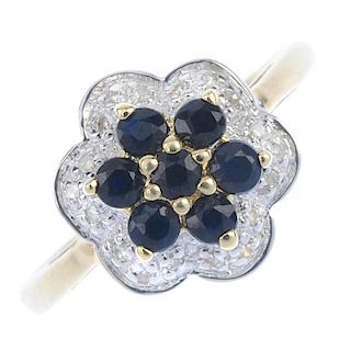 A 9ct gold sapphire and diamond cluster ring. The circular-shape sapphire cluster, within an illusio