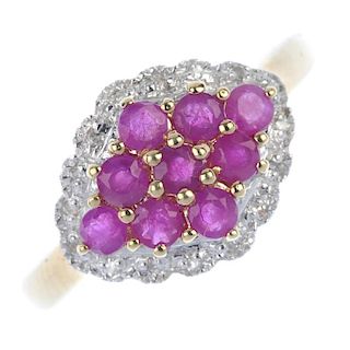 A 9ct gold ruby and diamond dress ring. Of marquise-shape outline, the circular-shape ruby cluster,