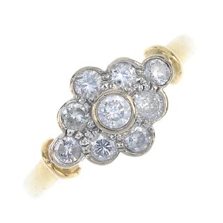 An 18ct gold diamond cluster ring. Of marquise-shape outline, the brilliant-cut diamond, within a si