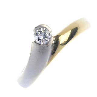 A diamond single-stone ring. Of bi-colour design, the brilliant-cut diamond, within a partial collet