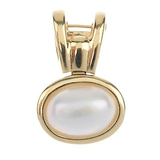 A mabe pearl pendant. The oval-shape mabe pearl collet, suspended from a bifurcated surmount. Length