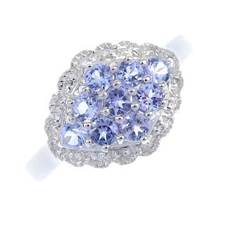 A 9ct gold tanzanite and diamond dress ring. Of marquise-shape outline, the circular-shape tanzanite