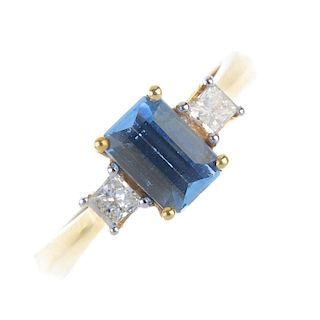 An 18ct gold aquamarine and diamond dress ring. The rectangular-shape aquamarine, with square-shape