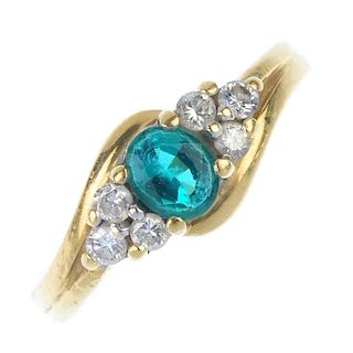 An 18ct gold synthetic emerald and diamond ring. The oval-shape synthetic emerald, with brilliant-cu