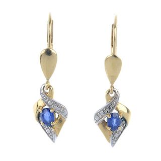 A pair of sapphire ear pendants. Each designed as an oval-shape sapphire, within a textured, bi-colo