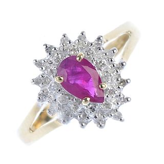 A 9ct gold ruby and diamond cluster ring. The pear-shape ruby, within a single-cut diamond double su