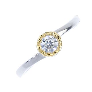A diamond single-stone ring. The brilliant-cut diamond, within a bi-colour, textured mount, to the p