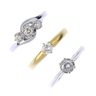 A selection of three diamond rings. To include a graduated brilliant-cut diamond diagonal line cross