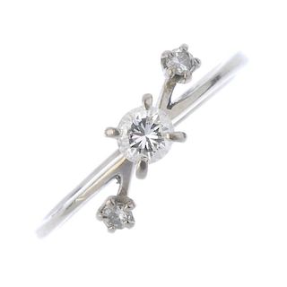 A diamond three-stone dress ring. The brilliant-cut diamond, with brilliant-cut diamond bar accents,