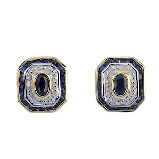 A pair of 9ct gold sapphire and diamond ear studs. Each designed as an oval-shape sapphire collet, w