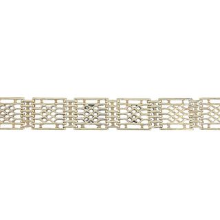 A 9ct gold gate bracelet. Designed as a series of lattice motifs links , to the lobster clasp and T-