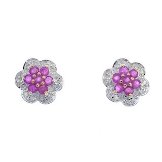 A pair of 9ct gold ruby and diamond flower cluster ear studs. Each designed as a circular-shape ruby