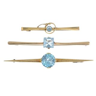 A selection of three brooches. To include a mid 20th century circular-shape zircon bar brooch, a squ