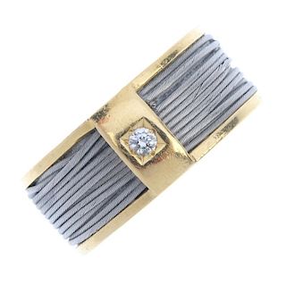 A diamond dress ring. The brilliant-cut diamond inset bar, atop a woven steel wrapped yellow metal b