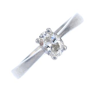 A platinum diamond single-stone ring. The oval-shape diamond, to the tapered shoulders and plain ban