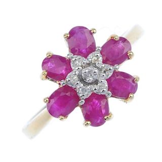 A 9ct gold ruby and diamond floral cluster ring. The single-cut diamond cluster, within an oval-shap