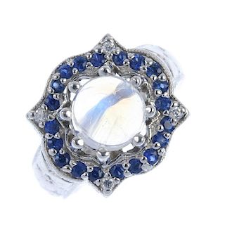 A 14ct gold moonstone, sapphire and diamond cluster ring. The circular moonstone cabochon, within a
