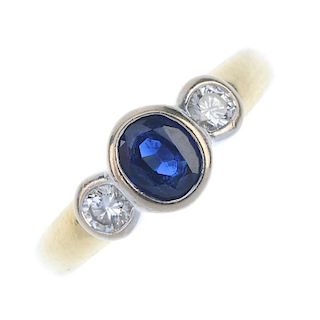An 18ct gold sapphire and diamond three-stone ring. The oval-shape sapphire collet, with brilliant-c