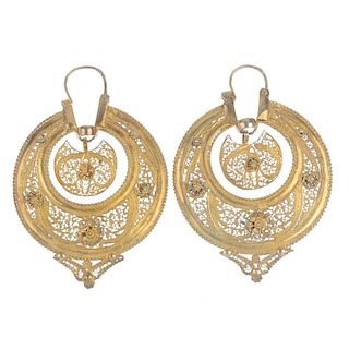 A pair of ear hoops. Each designed as a filigree crescent, suspended within a similarly-designed sur