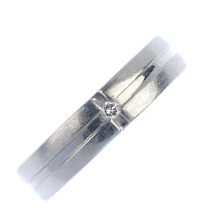 A platinum diamond band ring. The brilliant-cut diamond, inset to the grooved band. Diamond weight 0