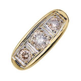 A gentleman's 18ct gold diamond three-stone ring. The graduated brilliant-cut diamond line, within a