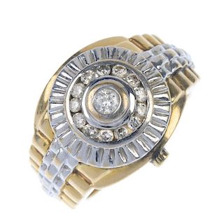 A gentleman's 9ct gold diamond dress ring. Designed as a stylised watch, the brilliant-cut diamond c