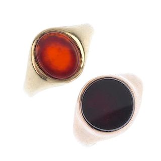 Two carnelian signet rings. Each designed as an oval or circular-shape carnelian, to the tapered sho