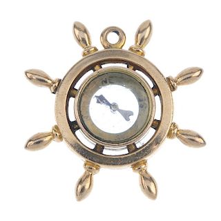 An early 20th century 9ct gold novelty compass fob. Designed as a ship's wheel, with central compass
