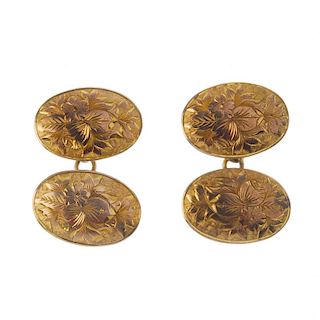 A pair of Edwardian 9ct gold cufflinks. Each designed as two oval-shape, floral engraved panels, con