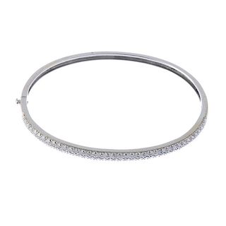 (57847) An 18ct gold diamond hinged bangle. The front designed as a pave-set diamond panel, to the p