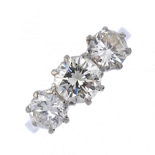 (161381) A diamond three-stone ring. The graduated brilliant-cut diamonds to the tapered shoulders a