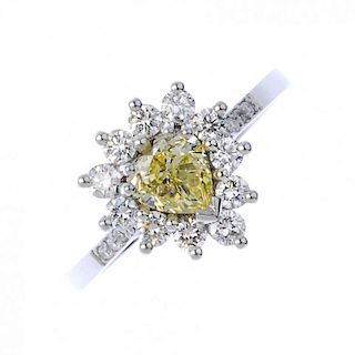 (194424) An 18ct gold coloured diamond and diamond cluster ring. The heart-shaped 'yellow' diamond w