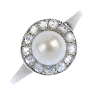 An early 20th century platinum cultured pearl and diamond cluster ring. The cultured pearl, measurin