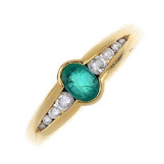 An 18ct gold emerald and diamond ring. The oval-shape emerald, with graduated brilliant-cut diamond