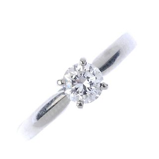 A platinum diamond single-stone ring. The brilliant-cut diamond, weighing 0.51ct, to the plain band.