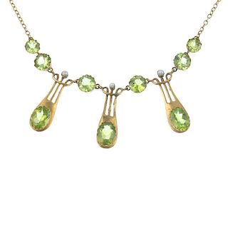 A peridot and seed pearl fringe necklace and matching ear pendants. The necklace designed as a serie