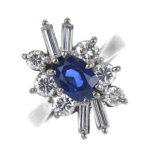 A sapphire and diamond dress ring. The oval-shape sapphire, within a brilliant and baguette-cut diam