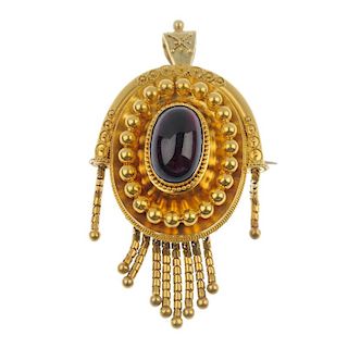 A late 19th century gold foil-back garnet pendant. The oval-shape foil-back garnet cabochon, within
