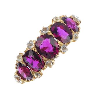 A ruby and gem-set dress ring. The graduated oval-shape rubies, with colourless gem intervals, to th