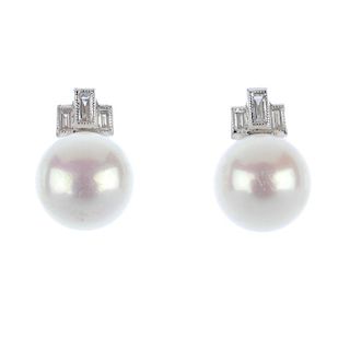 A pair of cultured pearl and diamond ear studs. Each designed as a cultured pearl, measuring 8mms, t