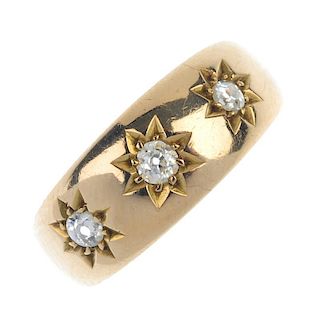 A late Victorian 18ct gold diamond three-stone dress ring. The old-cut diamond stars, inset to the t