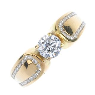 A diamond single-stone ring. The brilliant-cut diamond, raised to the channel-set brilliant-cut diam