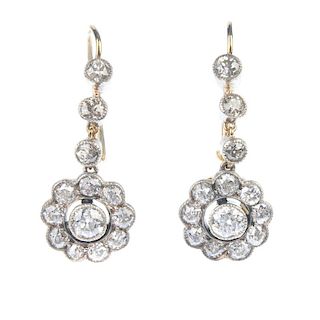A pair of early 20th century diamond floral ear pendants. Each designed as an old-cut diamond collet